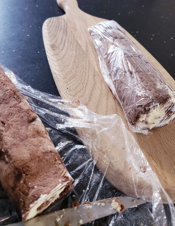 Unelmatorttu in plastic wrap. Chocolate dream roll in plastic wrap.