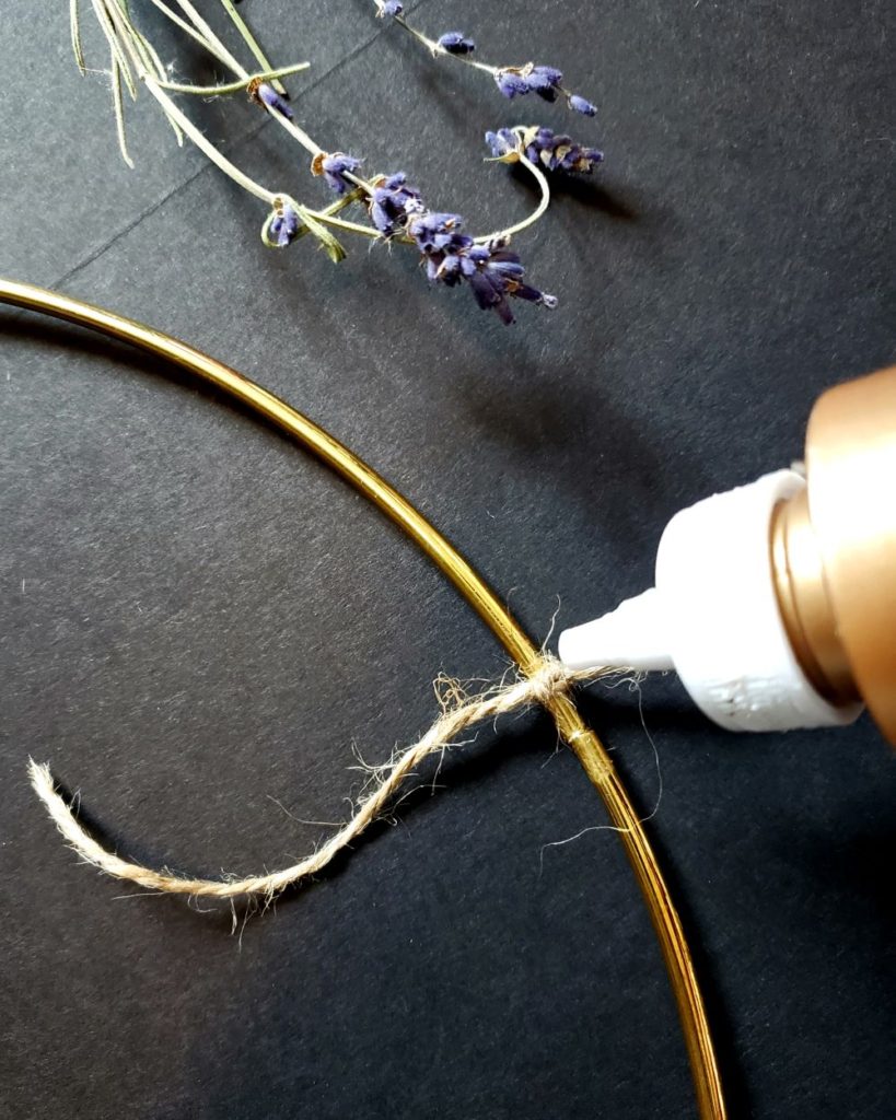 Gluing a jute knot on a wreath frame
