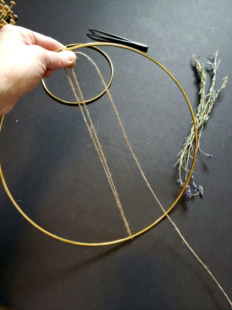 Starting to wrap jute around a wire wreath frame