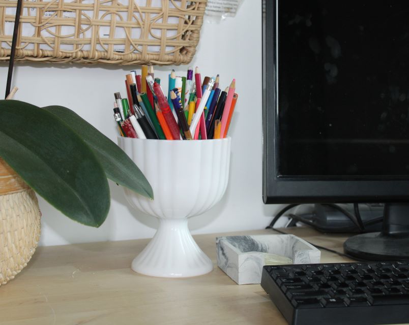Milk glass pedestal vase and pencils