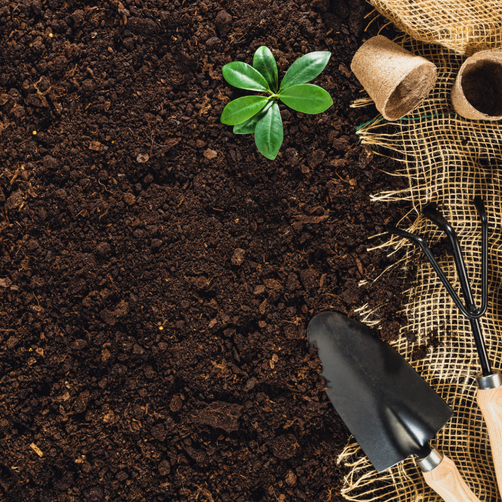 garden soil and a hand spade Up close photo of garden soil
