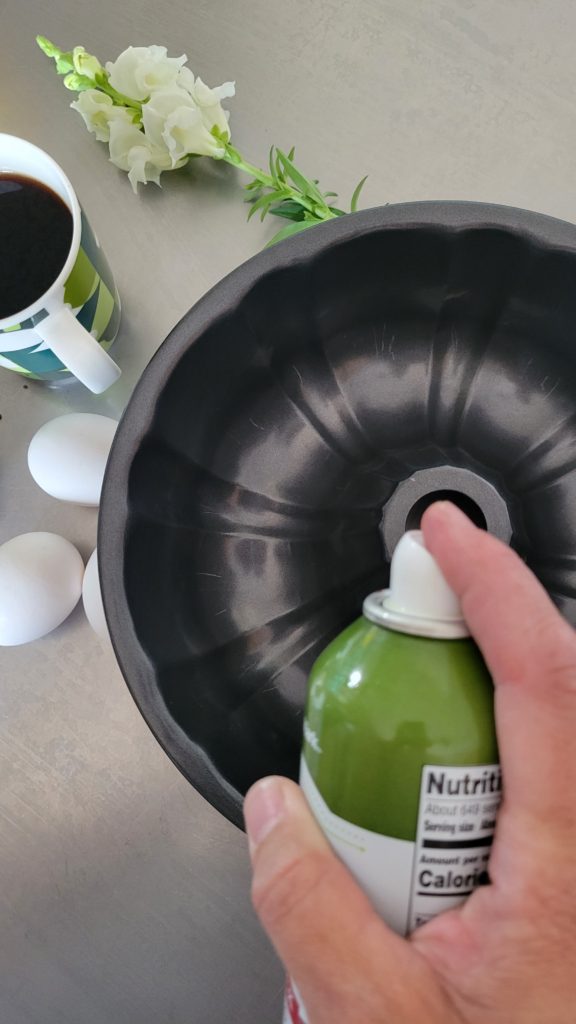 Spraying a bundt pan. Spraying a bundt pan with Canola oil spray.