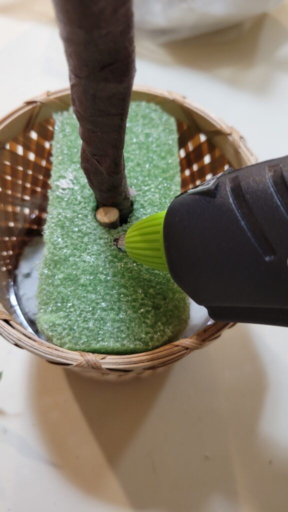 Hot gluing a stick into a pot